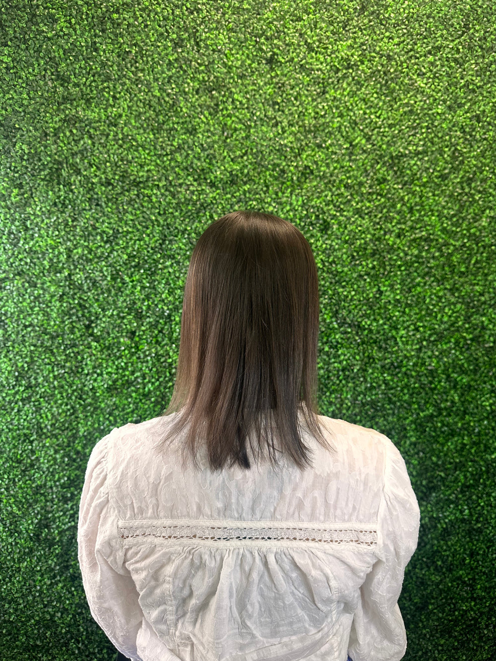 Brunette client back view before Studio Zeal hair enhancement